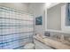 Bathroom features a marble countertop, stylish mirror, and striped shower curtain at 1722 Trewin Ct, Charleston, SC 29492