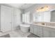 Elegant bathroom with a freestanding tub, double vanity, and light gray cabinets at 1722 Trewin Ct, Charleston, SC 29492