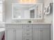 Bathroom features a marble countertop, double sinks, stylish cabinetry, and a large mirror at 1722 Trewin Ct, Charleston, SC 29492