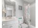 Well-lit bathroom features a single sink vanity, toilet, and shower with decorative curtain at 1722 Trewin Ct, Charleston, SC 29492