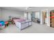 Bright bedroom boasts neutral walls, carpeted floors, with a cozy seating area and ensuite bathroom at 1722 Trewin Ct, Charleston, SC 29492