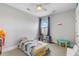 Bedroom with neutral walls, ceiling fan, and a school bus-themed bed at 1722 Trewin Ct, Charleston, SC 29492