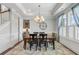 Formal dining area with stylish chandelier, wainscoting, and a view into the butler's pantry at 1722 Trewin Ct, Charleston, SC 29492