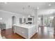 Open-concept kitchen with a large island, wood floors, and modern pendant lights at 1722 Trewin Ct, Charleston, SC 29492