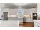 Bright kitchen with white cabinets, stainless steel appliances, and quartz countertops at 1722 Trewin Ct, Charleston, SC 29492