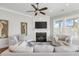 Cozy living room with fireplace, shiplap accent wall, and comfortable seating at 1722 Trewin Ct, Charleston, SC 29492