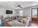 Bright play room features a large sectional sofa and an attached balcony at 1722 Trewin Ct, Charleston, SC 29492