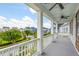 Inviting porch with white columns offers beautiful views of the community and landscaped street at 1722 Trewin Ct, Charleston, SC 29492