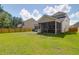 Backyard featuring an enclosed screened-in porch and a wood fence at 1888 Nola Run, Summerville, SC 29485