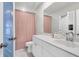 Bathroom featuring white vanity, pink shower curtain, and blue door at 1888 Nola Run, Summerville, SC 29485
