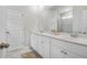 Modern bathroom with double vanity, white cabinets, and a large framed mirror for a clean, contemporary look at 1888 Nola Run, Summerville, SC 29485