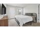 Bedroom with a door to a balcony, dresser, television, and neutral carpet at 1888 Nola Run, Summerville, SC 29485
