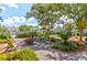 Charming community space with Adirondack chairs, a fire pit, playground, and lush landscaping perfect for relaxing and socializing at 1888 Nola Run, Summerville, SC 29485