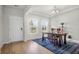 Bright dining room featuring a wooden table, patterned rug, and large windows and bright natural light at 1888 Nola Run, Summerville, SC 29485
