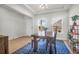 Bright dining room featuring a wooden table, patterned rug, and large windows and bright natural light at 1888 Nola Run, Summerville, SC 29485