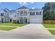 Charming two-story home with a welcoming front porch, attached garage and manicured lawn at 1888 Nola Run, Summerville, SC 29485