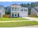 Charming two-story home with a welcoming front porch, attached garage and manicured lawn at 1888 Nola Run, Summerville, SC 29485