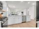 Bright kitchen with white cabinets, stainless steel appliances, and an open view of the living room at 1888 Nola Run, Summerville, SC 29485