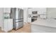 Modern kitchen with stainless steel appliances, white cabinets, and sleek countertops at 1888 Nola Run, Summerville, SC 29485