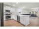 Well-lit kitchen featuring stainless steel appliances, a kitchen island, and an open view of the living area at 1888 Nola Run, Summerville, SC 29485