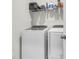 Convenient laundry room features modern washer and dryer, with storage shelving for cleaning supplies at 1888 Nola Run, Summerville, SC 29485