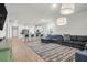 Open-concept living area with hardwood floors, modern lighting, and a seamless flow to the kitchen at 1888 Nola Run, Summerville, SC 29485