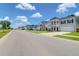 Street view showcasing the charming neighborhood with well-maintained homes and manicured lawns at 1888 Nola Run, Summerville, SC 29485