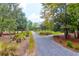 Scenic gravel walking path through the lush landscaping in the Summers Corner community at 1888 Nola Run, Summerville, SC 29485