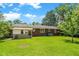 Expansive backyard features lush green grass and mature trees offering ample space and privacy at 1900 Morgan Ave, North Charleston, SC 29406
