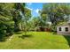 Large backyard with mature trees, lush green grass, and a storage shed; great for outdoor enjoyment at 1900 Morgan Ave, North Charleston, SC 29406