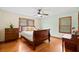Bedroom with a dark wood sleigh bed, ceiling fan, and hardwood floors at 1900 Morgan Ave, North Charleston, SC 29406