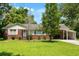Charming single-story home with brick accents, mature trees, and a covered carport, perfect for comfortable living at 1900 Morgan Ave, North Charleston, SC 29406
