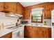 Charming kitchen with warm wood cabinets, modern appliances, and a bright window, creating a cozy cooking space at 1900 Morgan Ave, North Charleston, SC 29406