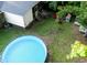 Aerial view of a home's backyard featuring an above-ground pool, patio area, and lush green lawn at 214 E Edgefield Dr, Summerville, SC 29483