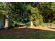 Backyard with a hammock strung between two trees, offering a tranquil spot for relaxation at 214 E Edgefield Dr, Summerville, SC 29483