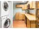 This basement kitchen features light wood cabinets, butcher block countertops, and a stackable washer/dryer at 214 E Edgefield Dr, Summerville, SC 29483