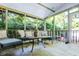 Comfortable sunroom featuring stone floors and wicker furniture, creating a relaxing indoor-outdoor living space at 214 E Edgefield Dr, Summerville, SC 29483