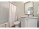 Stylish bathroom with a vanity, decorative mirror, and shower with a white tile surround at 2150 Terrabrook Ln, Charleston, SC 29412