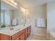 Bright bathroom featuring dual sinks, modern fixtures, and a large mirror at 2150 Terrabrook Ln, Charleston, SC 29412