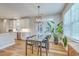 Dining area adjacent to the kitchen with a glass table, modern chairs, and access to outdoor space at 2150 Terrabrook Ln, Charleston, SC 29412