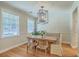 Elegant dining room featuring a rustic wood table, modern light fixture, and bright windows at 2150 Terrabrook Ln, Charleston, SC 29412