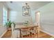 Bright dining area with a farmhouse table, contemporary lighting, and fresh floral centerpiece at 2150 Terrabrook Ln, Charleston, SC 29412