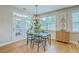 Charming dining space with glass top table, modern light fixture, with French doors to outdoor patio at 2150 Terrabrook Ln, Charleston, SC 29412