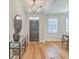 Inviting entryway with hardwood floors, stylish lighting, console table, and mirror at 2150 Terrabrook Ln, Charleston, SC 29412