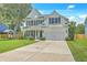 Beautiful two-story home with manicured lawn, mature trees, and attached two-car garage at 2150 Terrabrook Ln, Charleston, SC 29412
