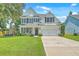 Charming home with a manicured lawn, lovely landscaping, and an attached two-car garage at 2150 Terrabrook Ln, Charleston, SC 29412