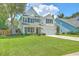 Charming two-story home featuring a manicured lawn, well-maintained landscaping, and a welcoming front porch at 2150 Terrabrook Ln, Charleston, SC 29412