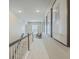 Bright hallway with framed pictures, stairwell, and chair at 2150 Terrabrook Ln, Charleston, SC 29412