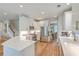 Modern kitchen featuring white cabinets, stainless steel appliances, quartz countertops, and hardwood flooring at 2150 Terrabrook Ln, Charleston, SC 29412