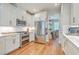 Well-equipped kitchen featuring stainless steel appliances, white cabinets, and hardwood floors at 2150 Terrabrook Ln, Charleston, SC 29412